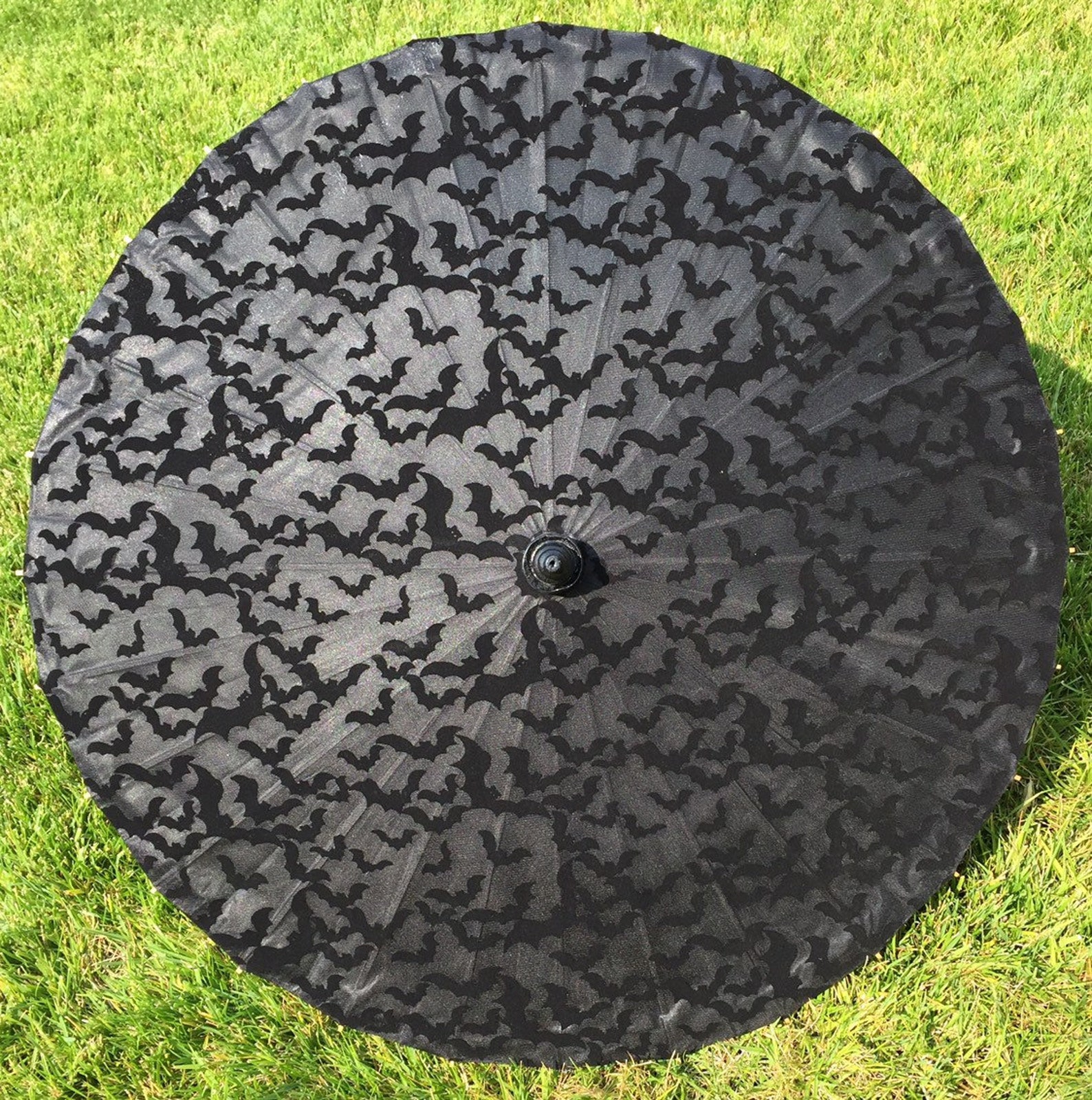 Black gothic parasol with all-over bat print, perfect for sun protection and alternative summer fashion styling