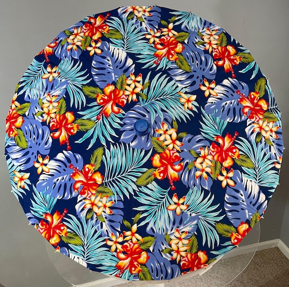 tropical parasol with blue leaves and white hibiscus