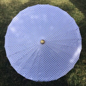 White parasol with gold polka dots