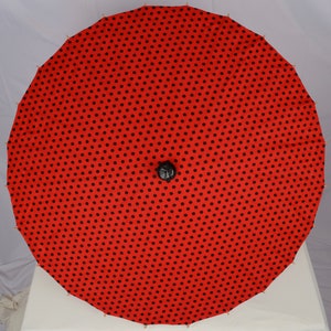 Red parasol with black polka dots