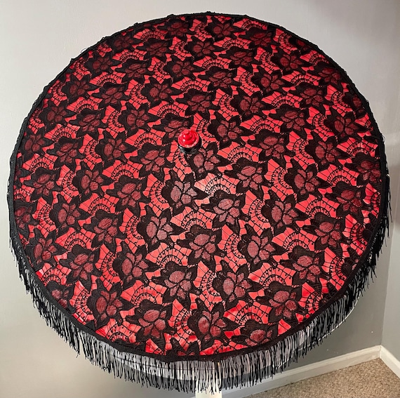 Black lace on a red parasol with fringe