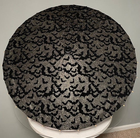 Black Bats with gold tulle on a black parasol