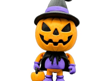 May include: A Halloween-themed figurine of a jack-o'-lantern wearing a witch's hat and cape. The orange pumpkin head has carved eyes and a mouth. The figure is wearing a black cape, purple outfit, and holding a small pumpkin basket.