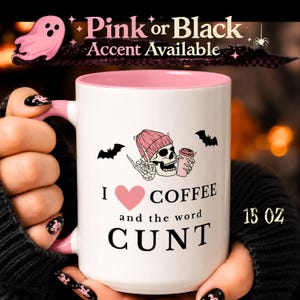 May include: A 15 oz white ceramic mug with a pink interior and handle. The design features a skull wearing a pink beanie, holding a coffee cup, flanked by two black bats. Text reads: I heart COFFEE and the word CUNT. Pink or Black Accent Available.