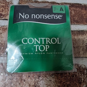 May include: A package of No nonsense brand control top premium nylon pantyhose in tan with a sheer toe. The packaging is green and black with white text that reads No nonsense, CONTROL TOP, and PREMIUM NYLON PANTYHOSE, with size A indicated.