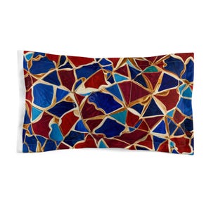 May include: A pillowcase featuring a geometric pattern of red, blue and gold mosaic tiles.