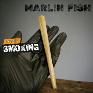 May include: A light-colored wooden pipe held in a gloved hand. The text "MARLIN FISH" is above the pipe, and "PIPE SMOKING" is in a banner below. The background is a gradient of gray and brown.