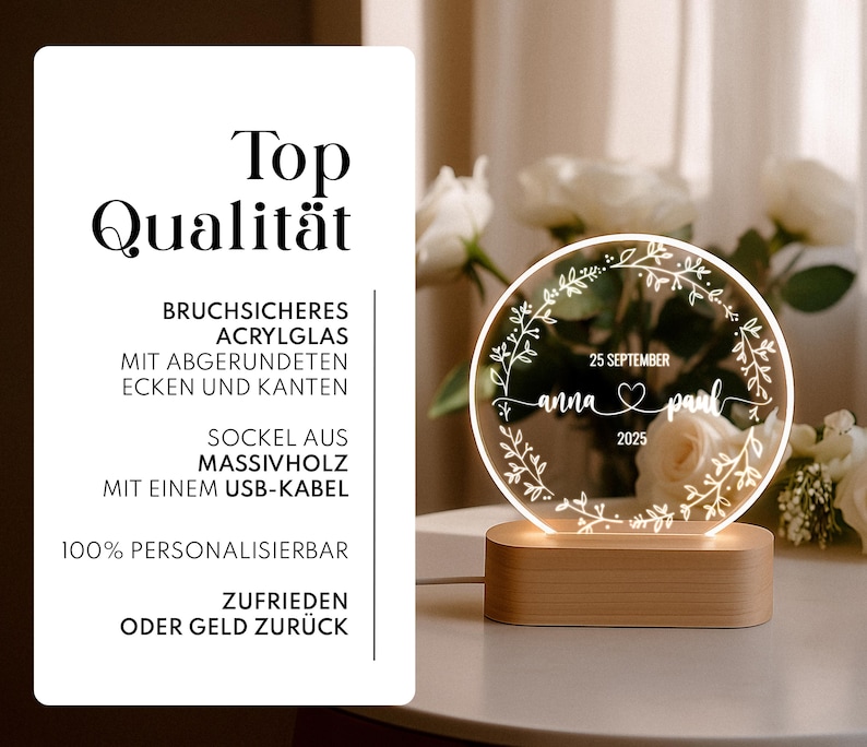 May include: A personalized LED night light with a wooden base. The round, clear acrylic light features the names "anna & paul", the date "25 September 2025", and a floral wreath design. The text "Top Qualit&auml;t" is also visible.