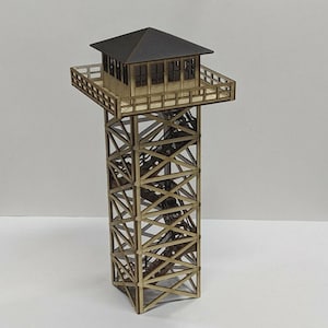 May include: A wooden model of a fire lookout tower. The tower has a dark brown roof and a square observation deck with windows. The support structure is made of crisscrossing wooden beams, creating a detailed miniature.