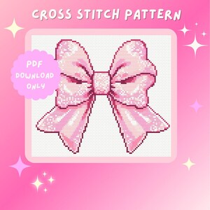 May include: A pink cross stitch pattern of a large bow. The pattern is in a white square frame with a pink background. The text "PDF DOWNLOAD ONLY" is in a white cloud shape with a pink outline.