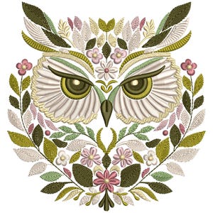 May include: Embroidered design of an owl's face surrounded by green leaves and pink flowers. The owl's eyes are large and green, and its feathers are white and cream.