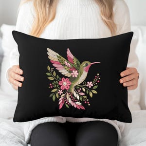 Floral hummingbird machine embroidery design with pink flowers, green leaves, cream feathers and botanical branches.
