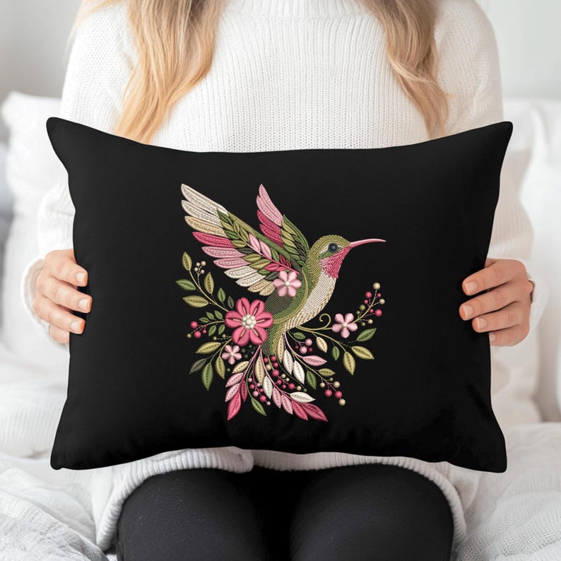 Floral hummingbird machine embroidery design with pink flowers, green leaves, cream feathers and botanical branches.
