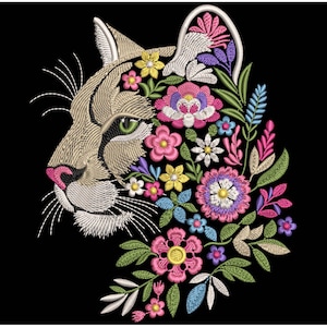 May include: Embroidered design of a cougar's profile, featuring a tan face with green eyes and a pink nose. The cougar's form is filled with colorful flowers in shades of pink, yellow, blue, and purple, set against a black background.