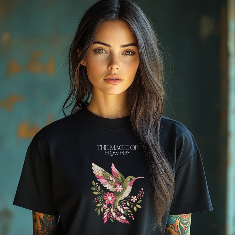 Floral hummingbird machine embroidery design with pink flowers, green leaves, cream feathers and botanical branches.
