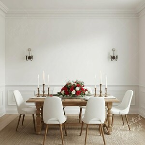 May include: A dining room scene with a wooden table set with white candles and a floral centrepiece of red and white roses. White chairs surround the table, and sconces adorn the white walls.