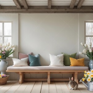 May include: A wooden bench with a white cushion and five pillows in various colors, including pink, teal, white, green, and yellow. A small rabbit sits on the floor in front of the bench.