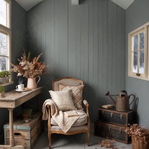 May include: A cosy living room corner featuring a wooden armchair, a throw blanket, and a book. The room has a rustic feel with wooden walls and a vintage watering can on a wooden chest.