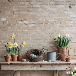 May include: A rustic still life featuring a bird's nest filled with blue Easter eggs, a watering can, and three potted daffodils. The scene is set against a brick wall background.