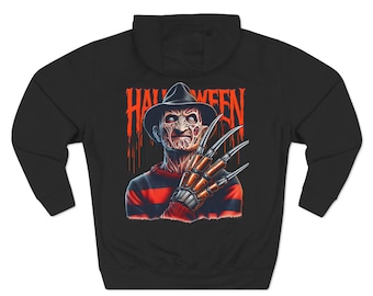 Könnte beinhalten: Schwarzer Kapuzenpullover mit einem Grafikdruck von Freddy Krueger aus dem Film "Nightmare on Elm Street". Die Grafik zeigt Freddy Krueger mit seinem charakteristischen Handschuh und dem Wort "Halloween" in Rot.