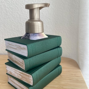 May include: A rustic wooden sign with the text "Welcome" in a handwritten style. The sign is painted white with a distressed finish, and a small, decorative heart is attached to the bottom. The background is a blurred image of a wooden surface.