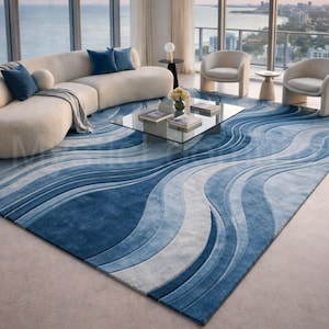 Modern blue abstract hand-tufted wool area rug with wave design placed in a luxury contemporary living room with sofa and glass table.