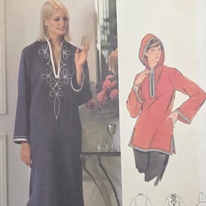 May include: Butterick 5116 sewing pattern envelope for size 14. The front features a long navy blue dress with white trim and embroidery, and a shorter red hooded tunic with long sleeves. Includes line drawings of the front and back views.