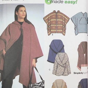 May include: Simplicity sewing pattern featuring a woman wearing a hooded cape. The pattern includes designs for capes, ponchos, and a scarf. The pattern is labeled "6 made easy!" and "Designs by Karen Z."