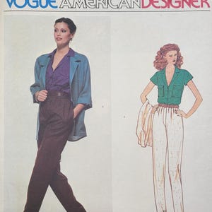 May include: Vogue American Designer sewing pattern featuring Anne Klein designs. The cover shows illustrations of two outfits: a woman in a purple blouse, brown pants, and a blue jacket, and another in a green shirt and white pants. The pattern number is 2136.