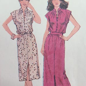May include: Two women's dress patterns, one with a white and black polka dot print and the other a solid pink. Both dresses have a V-neckline and a button-up front. The dress on the left is knee-length, while the dress on the right is floor-length. The pattern numbers are 2 and 3.