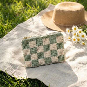 Tapestry crochet checkered pouch on a linen picnic blanket outdoors