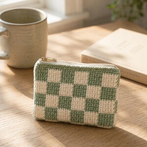 Beginner friendly crochet clutch bag next to a mug and an open book