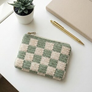 Crochet zipper pouch used as a pencil case on a desk, made from a PDF pattern