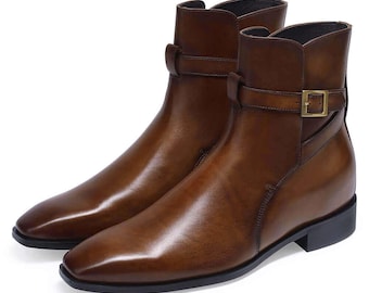 May include: A pair of brown leather ankle boots with a buckle strap and a pointed toe.