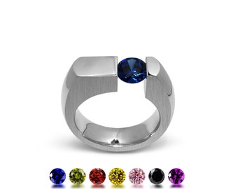 COLONNA Flat style ring with a off centered tension set colored gemstone in stainless steel by Taormina Jewelry