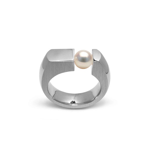 COLONNA Flat style ring with an off centered tension set White Pearl in stainless steel by Taormina Jewelry