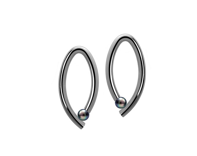 OVUM oval cat eye shaped drop stud earrings with tension set black pearls in stainless steel by Taormina Jewelry