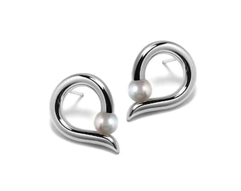 ONDE Teardrop shaped stud earrings with tension set white pearl in stainless steel by Taormina Jewelry