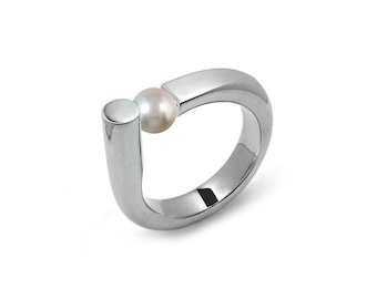 COLONNA Rounded style ring with a off centered tension set white pearl in stainless steel by Taormina Jewelry