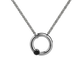 LUNA round tubular pendant hanging on a chain with tension set off centered black diamond in stainless steel by Taormina Jewelry
