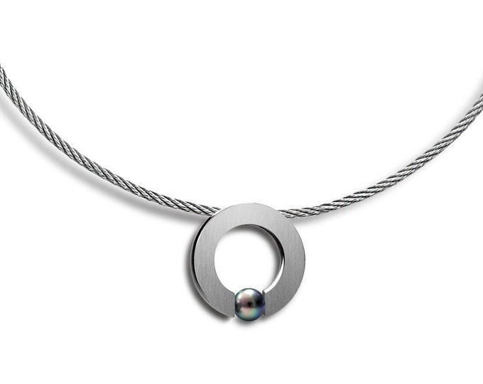 ABBRACCI round flat pendant with tension set black pearl on a cable choker in stainless steel by Taormina Jewelry