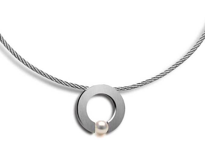 ABBRACCI round flat pendant with tension set white pearl on a cable choker in stainless steel by Taormina Jewelry