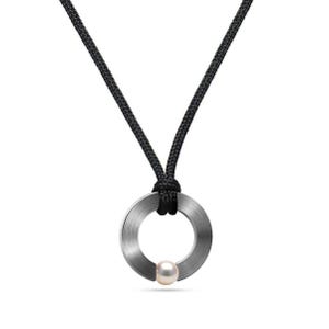 May include: A silver ring pendant with a white pearl, hanging from a black cord necklace.