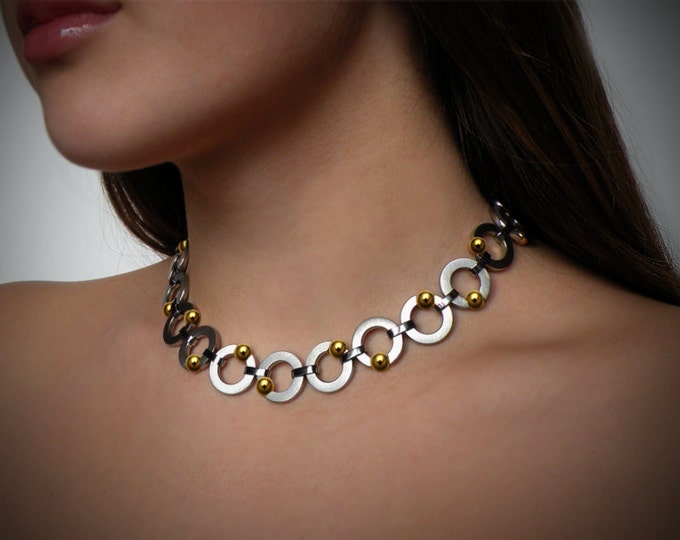 ABBRACCI round flat link necklace with tension set gold spheres in stainless steel by Taormina Jewelry