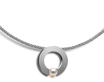 ABBRACCI round flat pendant with tension set white pearl on a cable choker in stainless steel