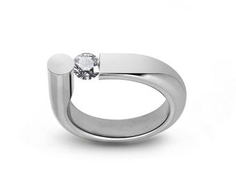 PORTANTE Flat and tubular ring with off centered tension set white sapphire in stainless steel
