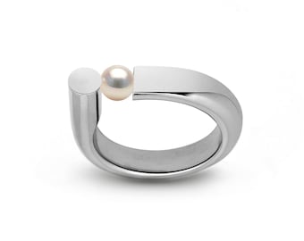 PORTANTE Flat and tubular ring with off centered tension set white pearl in stainless steel