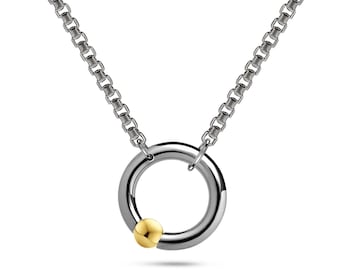 LUNA round tubular pendant with an off centered tension set gold sphere on a box chain in stainless steel