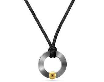 ABBRACCI flat round pendant on a cord with tension set gold sphere in stainless steel