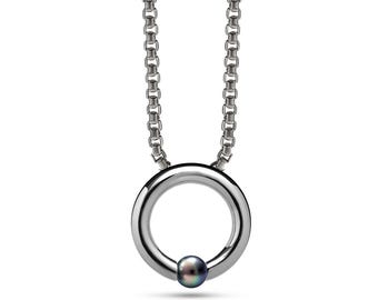 LUNA round tubular pendant hanging on a chain or cord with tension set black pearl in stainless steel
